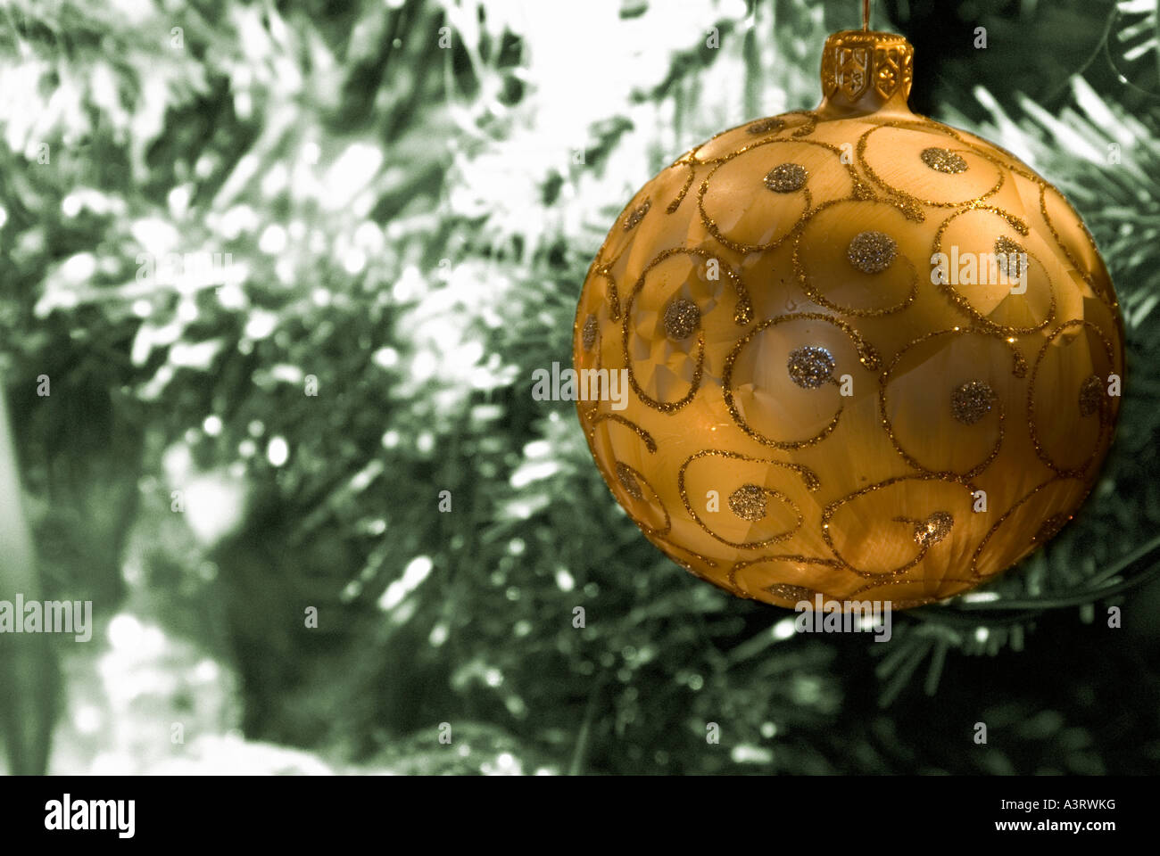 Gold Christmas tree decoration against toned christmas tree background Stock Photo