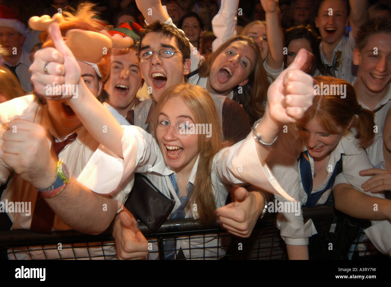 Back To Skool disco night Aberystwyth university  crowd of students union happy blonde woman dressed as  schoolgirl thumbs up Stock Photo