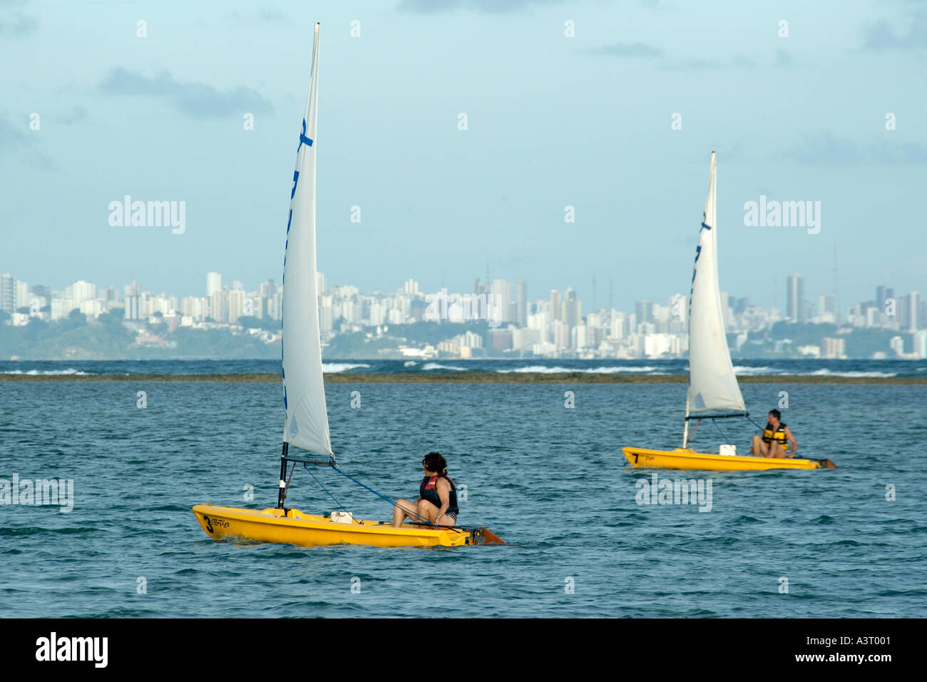 Resort tourists enjoy windsurfing on the waters of Todos os Santos Bay at Itaparica Island Bahia Brazil Stock Photo
