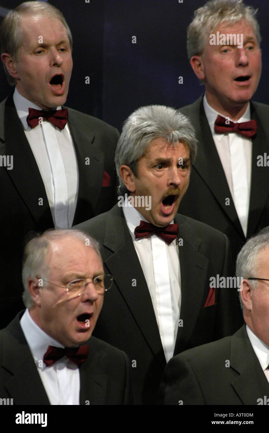 A group of men singing in a traditional welsh male voice choir singing in competition for best choir in Wales Stock Photo