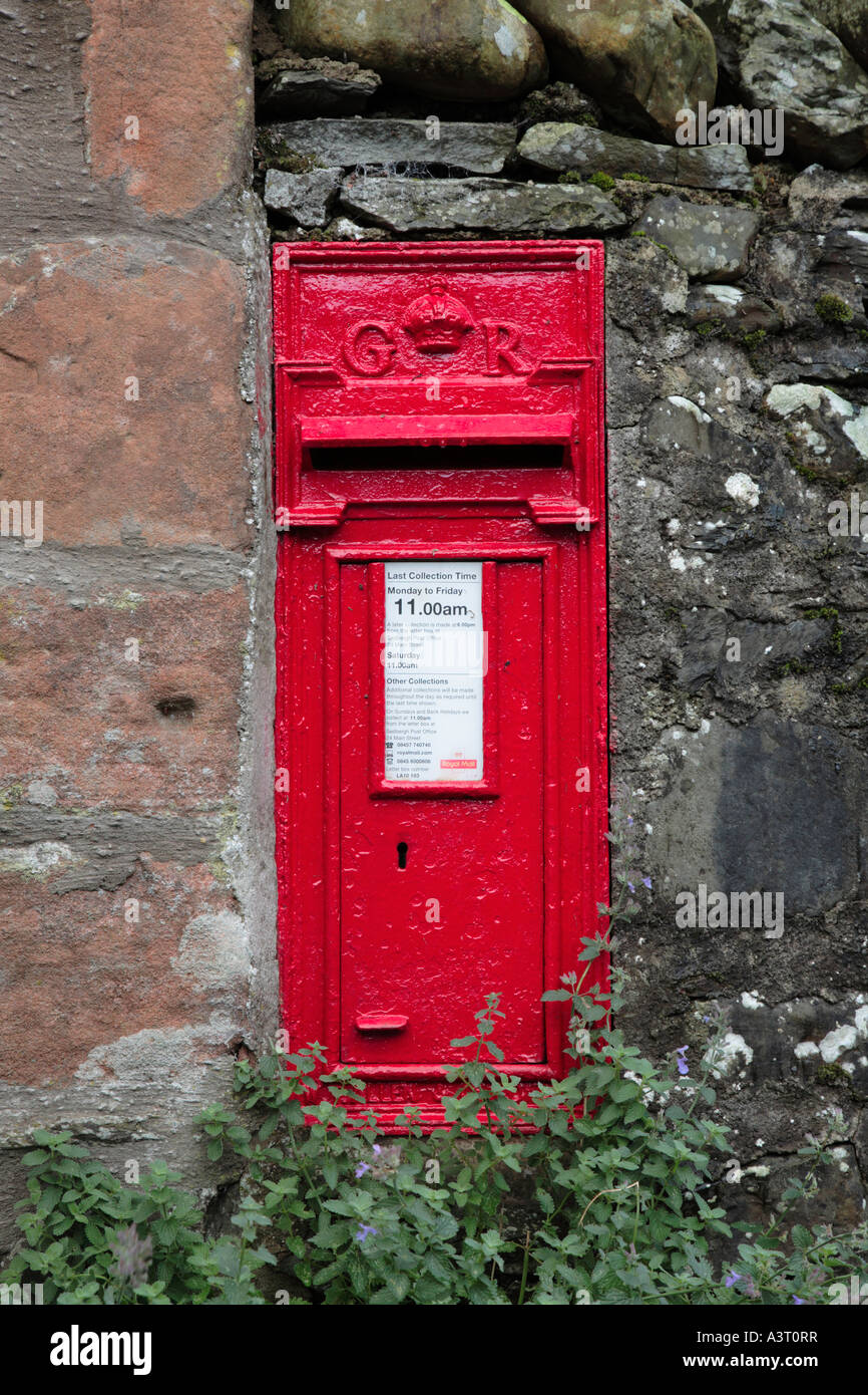 Traditional postbox built into lakeland dry stone wall in Cumbria England Stock Photo