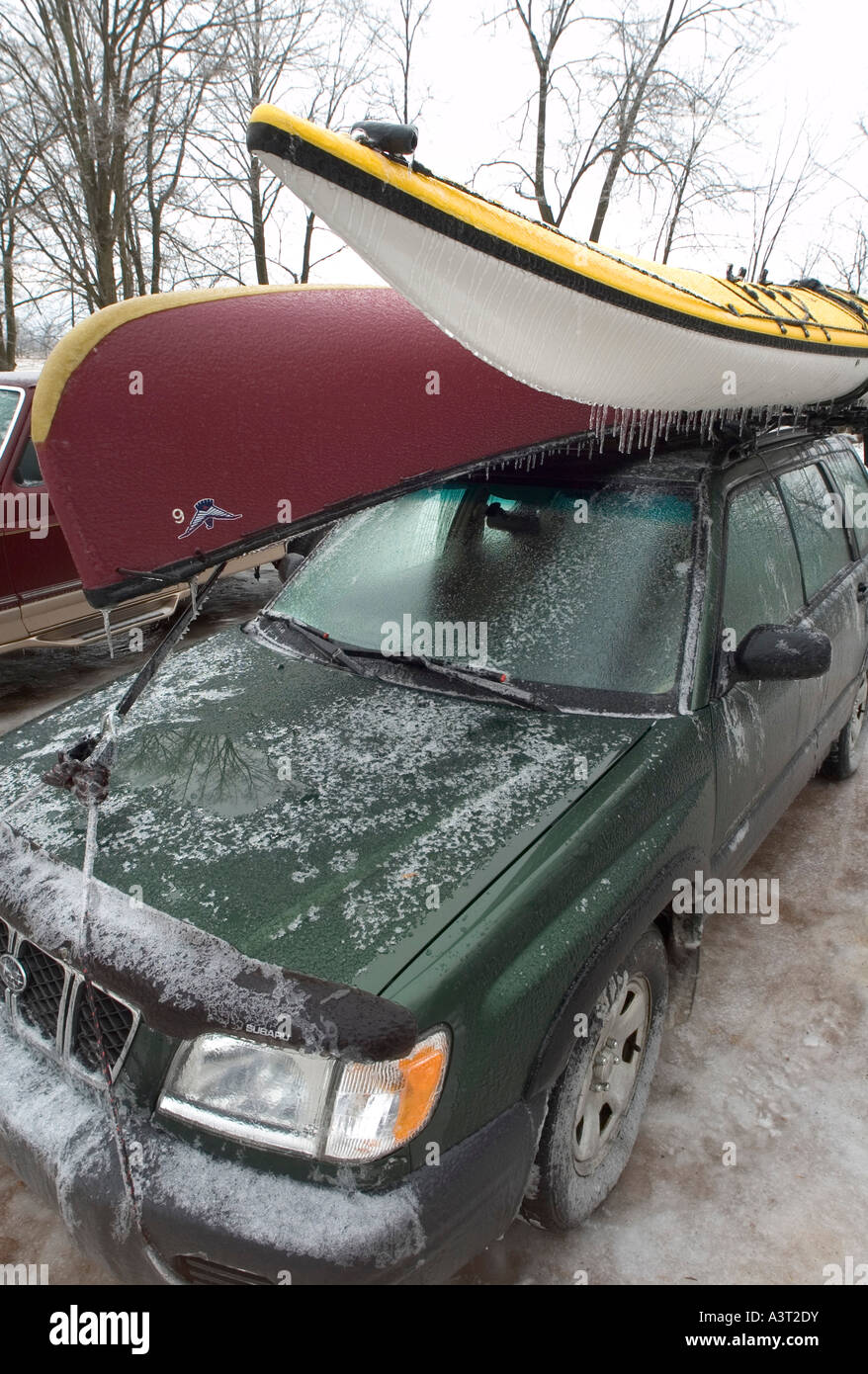 Car with canoe and sea kayak on top after ice storm Wisconsin