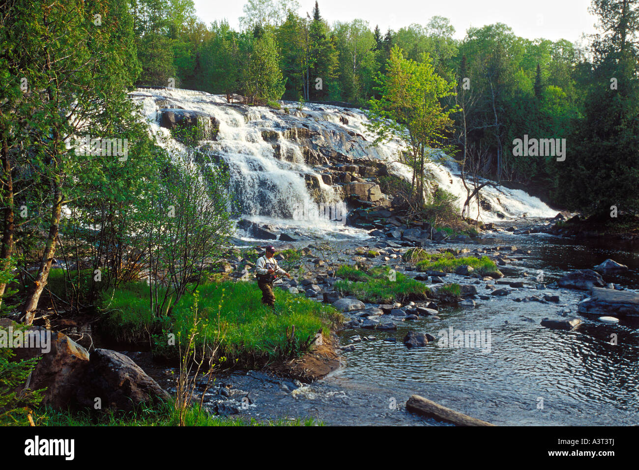 A trout fisherman in spring below Bond Falls on the Ontonagon River
