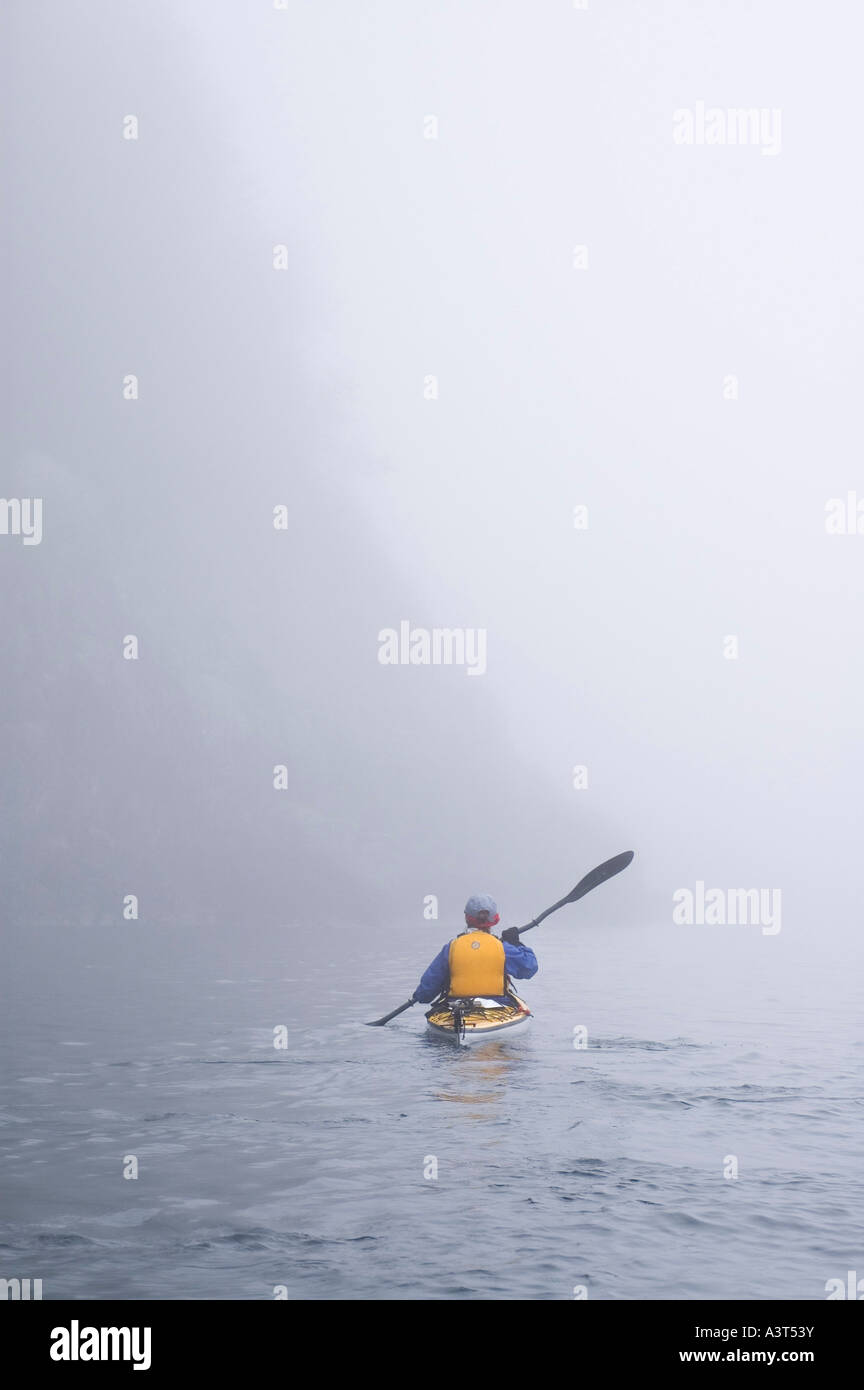 A sea kayaker paddles through the fog in Lake Superior Provincial Park