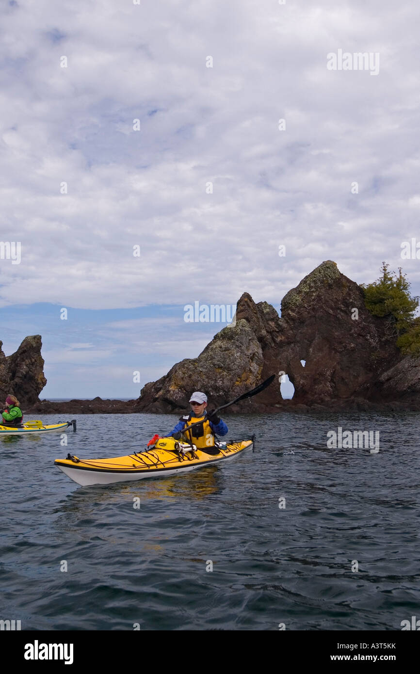 A Sea Kayaker Explores The Rock Formation Known As Devils