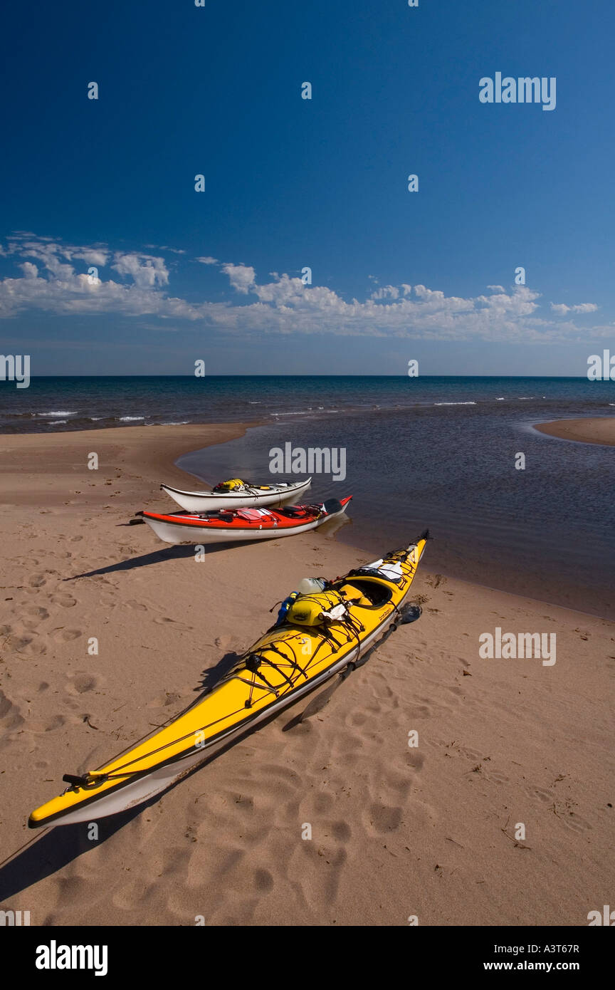 Sea kayaks on a sand beach at the mouth of the Iron River near Big Bay ...