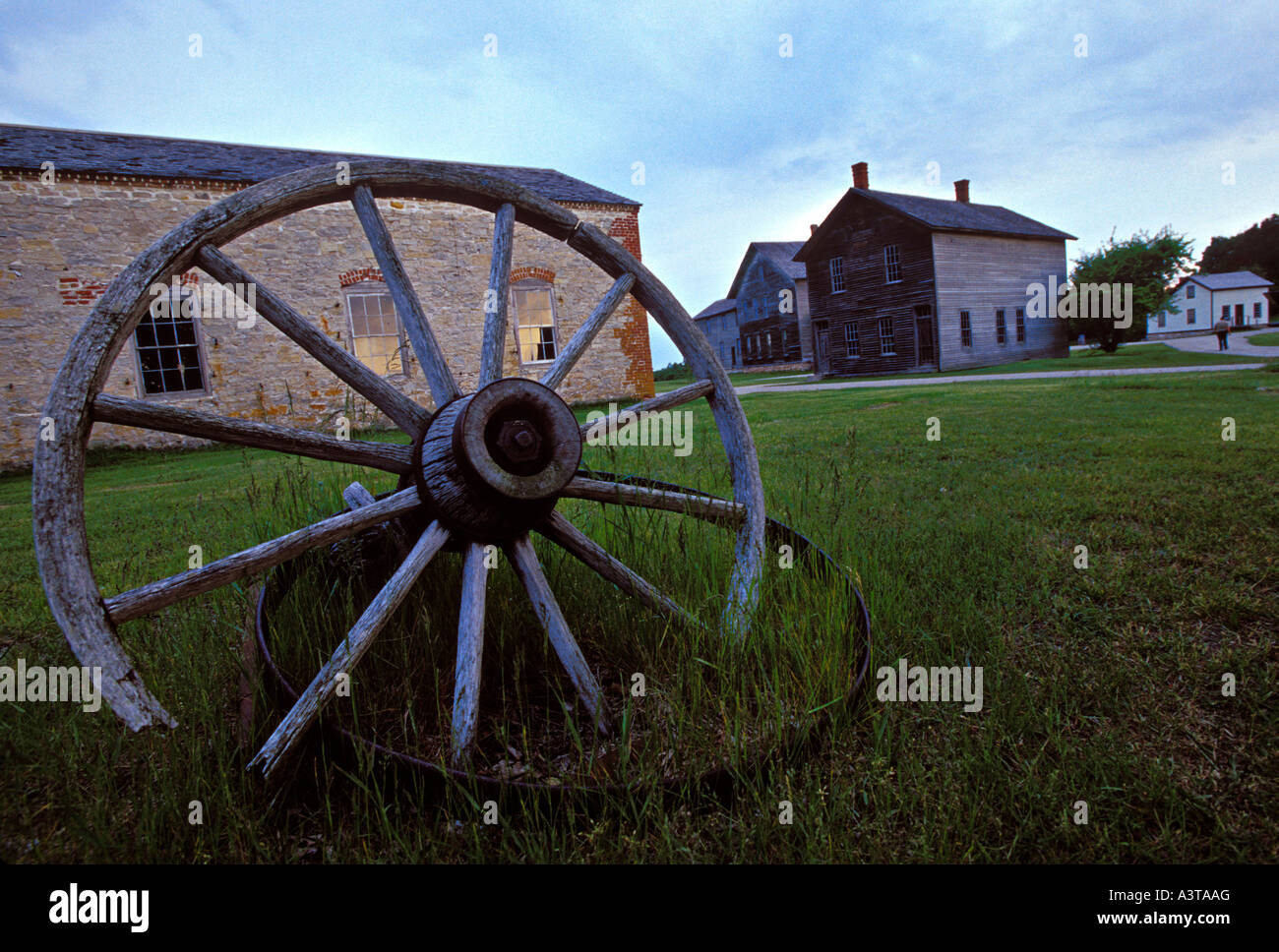 A WAGON WHEEL SITS AMONG NINETEENTH CENTURY BUILDINGS AT FAYETTE STATE HISTORIC PARK ON THE GARDEN PENINSULA Stock Photo