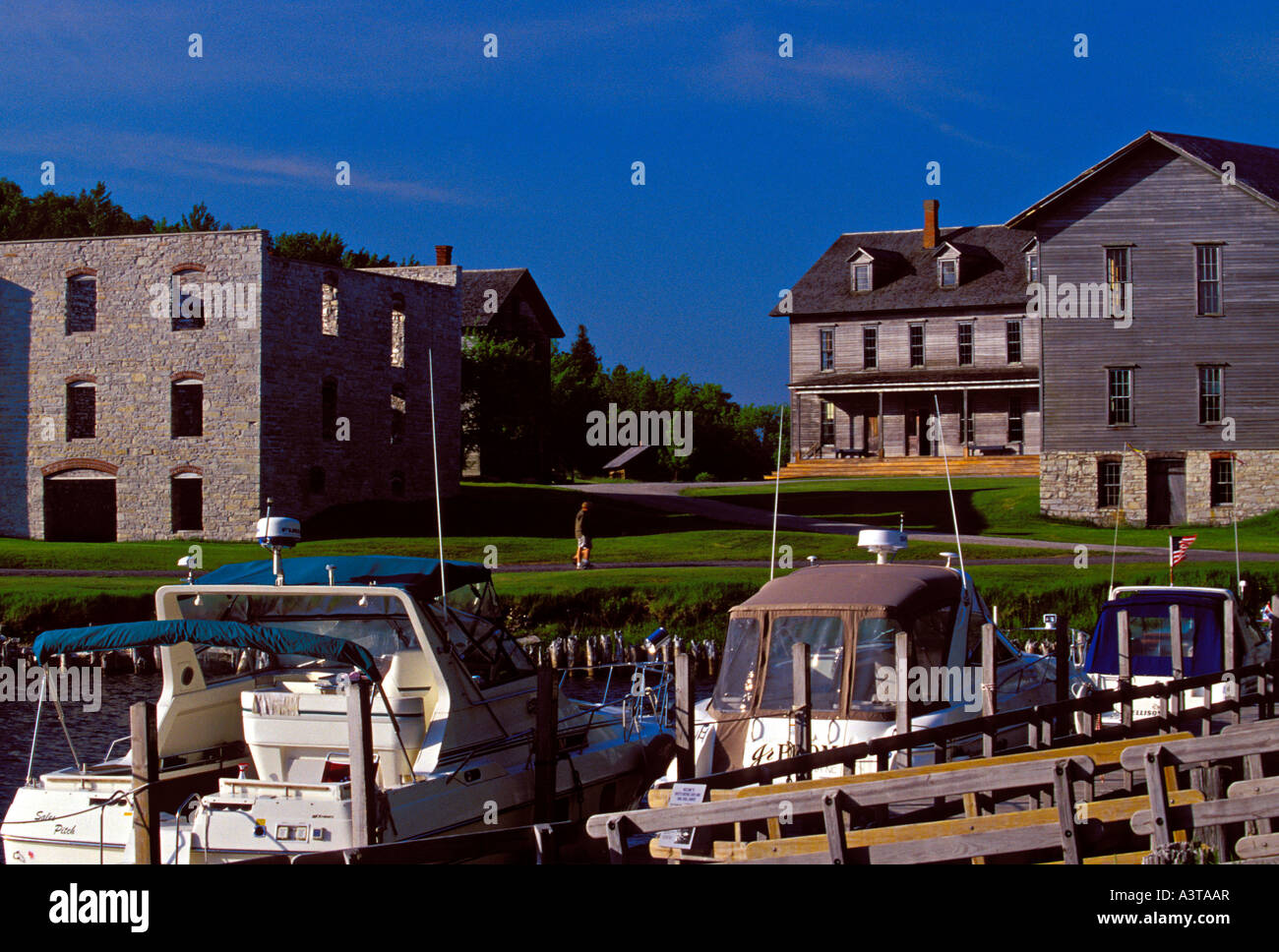 BOATS DOCK IN SNAIL SHELL HARBOR NEAR NINETEENTH CENTURY BUILDINGS AT FAYETTE STATE HISTORIC PARK ON THE GARDEN PENINSULA Stock Photo