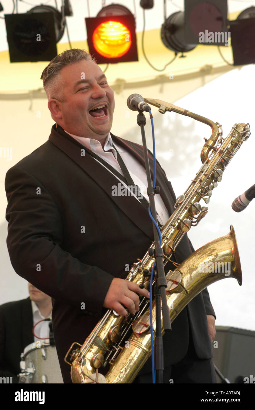aberystwyth arts centre summer festival 'midsummer madness' music festival smiling white man with bass saxophone, Wales UK Stock Photo