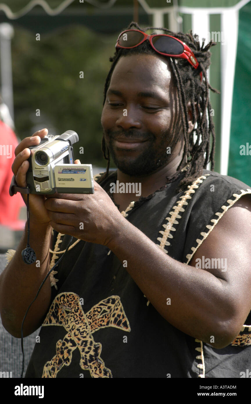 aberystwyth arts centre summer festival 'midsummer madness' black man using  small digital video camera Stock Photo - Alamy