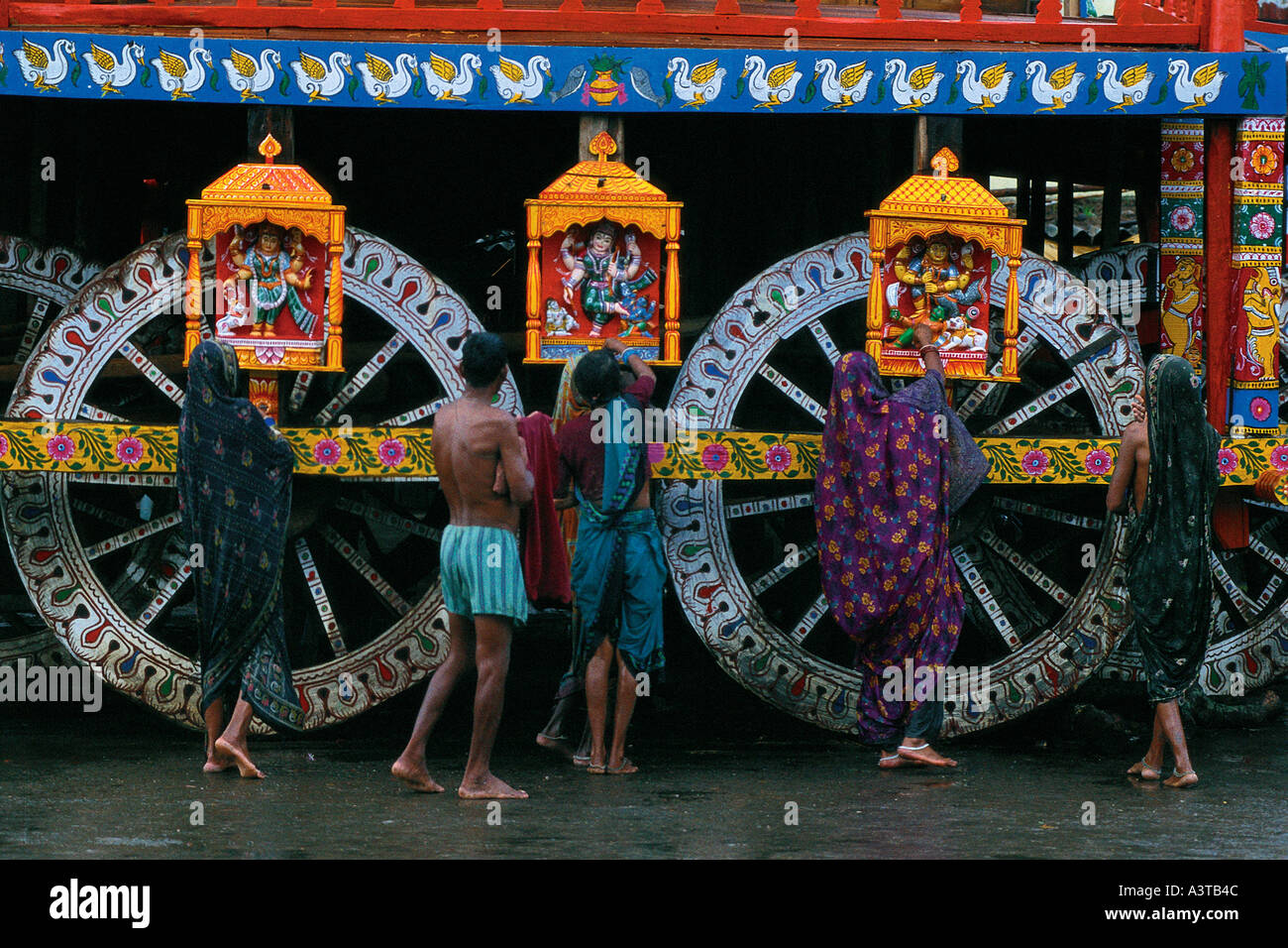 Pilgrims praying at Wheels of Jaganath Chariot in Puri India during festival Stock Photo
