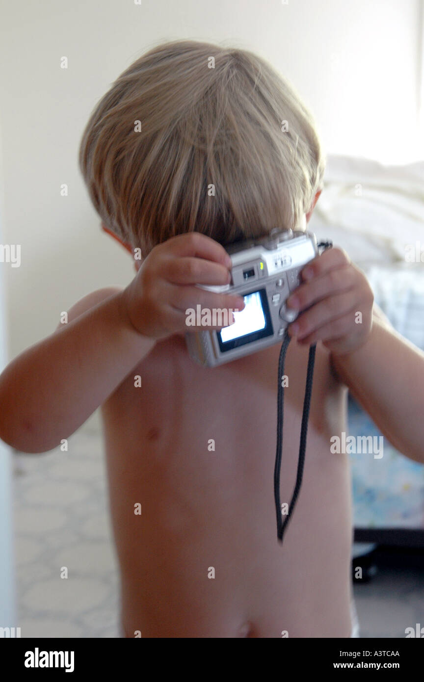 little boy using small digital camera backwards humour humor funny ...