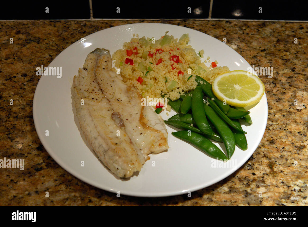 Sea Bass Couscous and mange tout Stock Photo Alamy