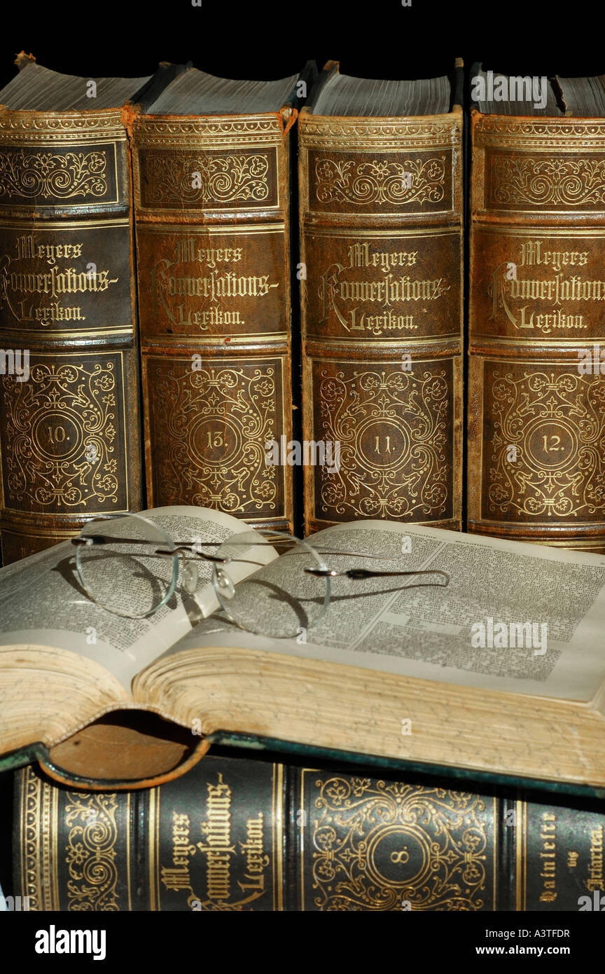 Reading glasses on open volume of an old edition of Meyers lexicon Stock Photo