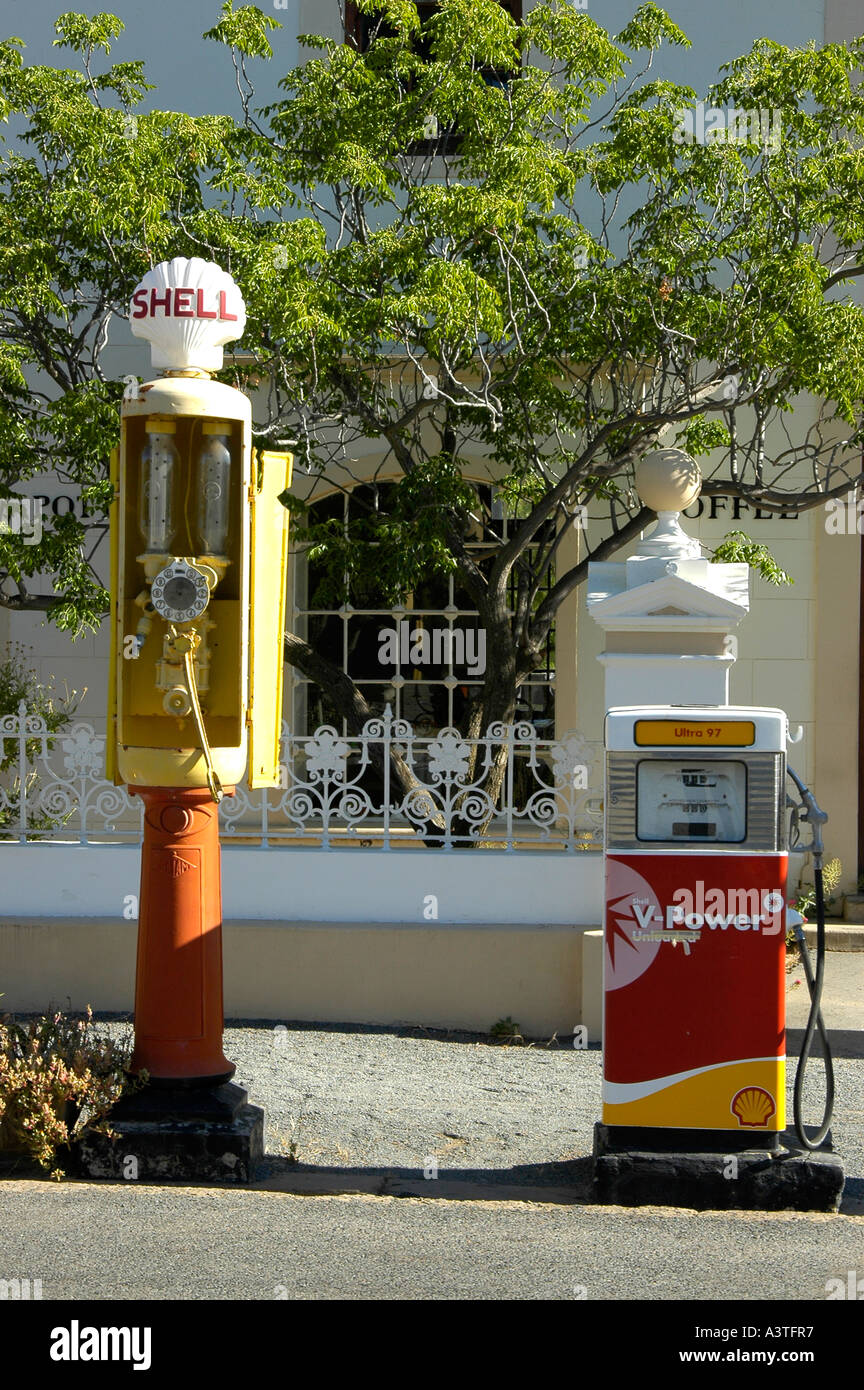 Historic petrol pump contrasted with more modern one in historic