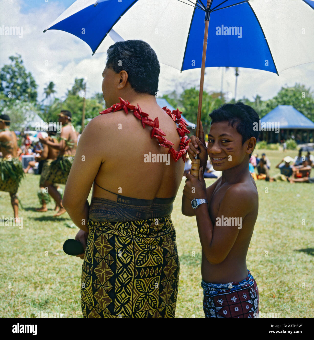Western Samoan father with traditional tattoo and his son holding sun  brolly in Apia on Upolu Is Western Samoa Stock Photo - Alamy