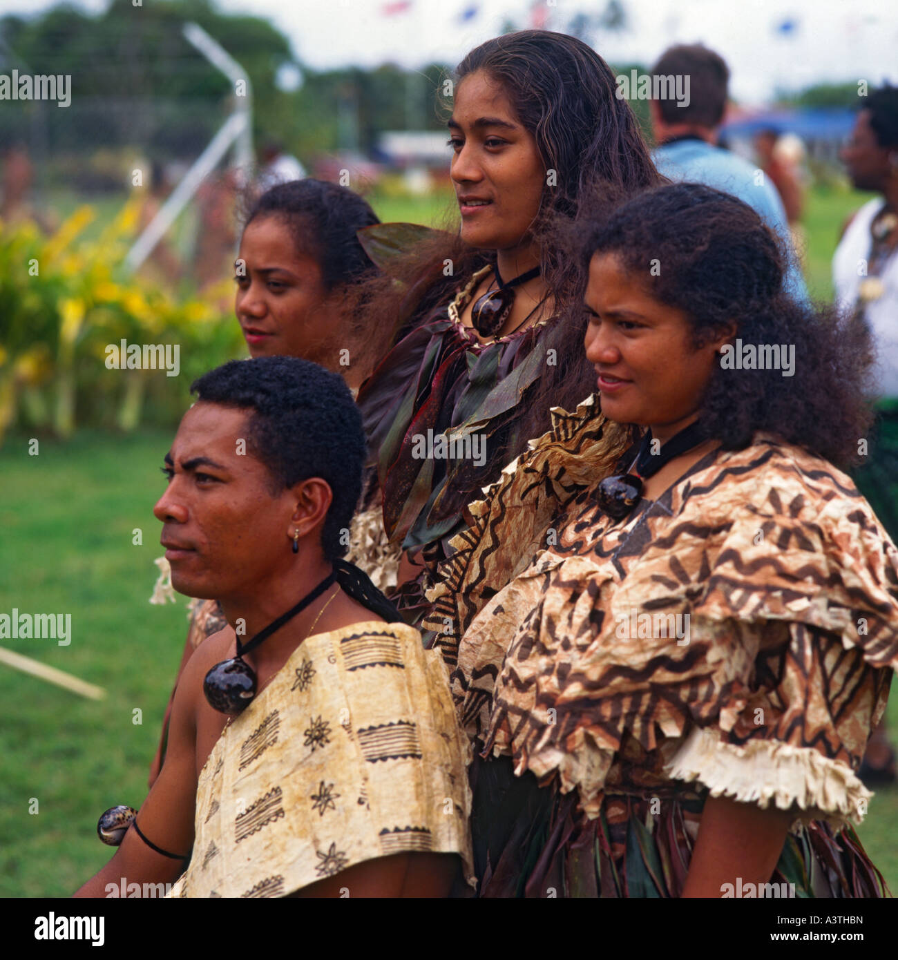 Group of dark skinned dancers from Futuna Island in tapa cloth costume with cowrie shell necklaces at Pacific Arts Festival Stock Photo