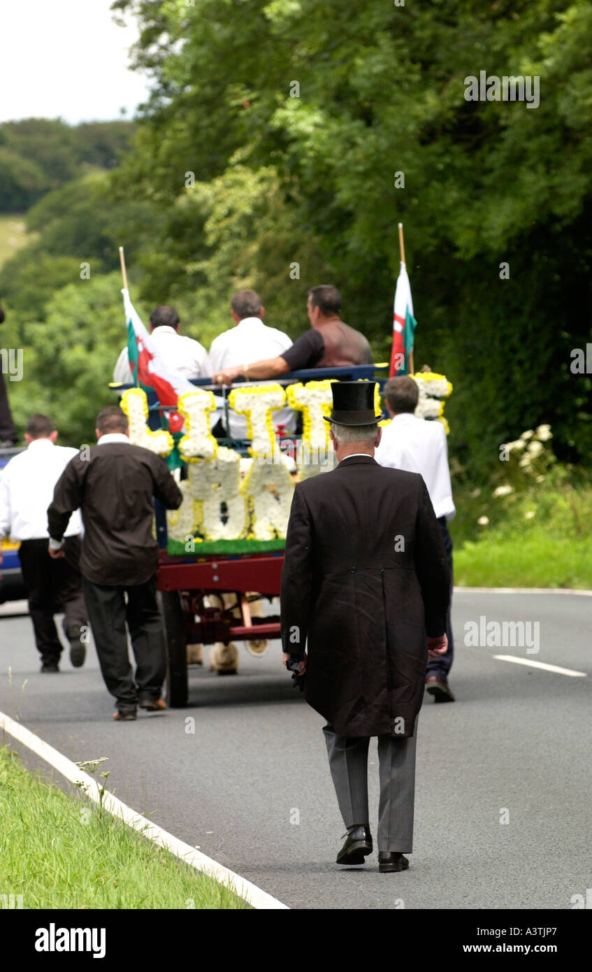 Gypsy funeral cortege using horse and cart to carry the coffin at
