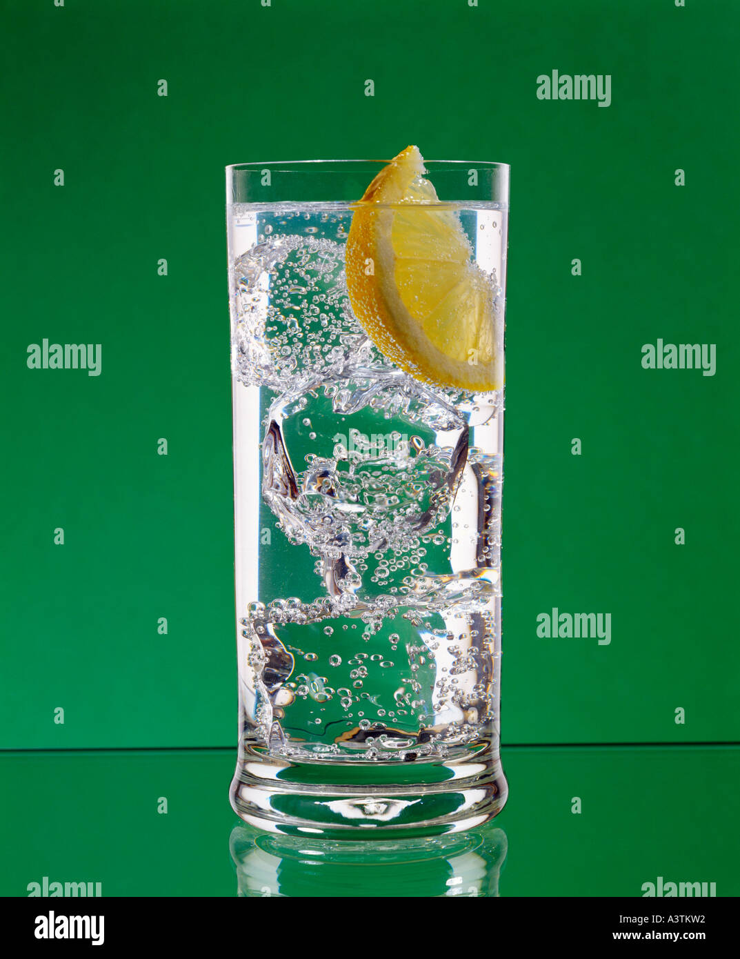 Gin and tonic with ice and lemon in long glass Stock Photo