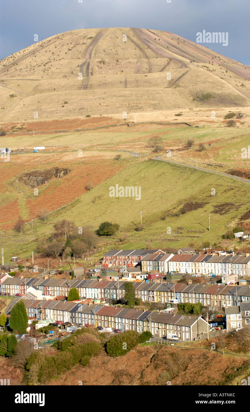 Terraced houses built to house colliery workers with coal tip above at