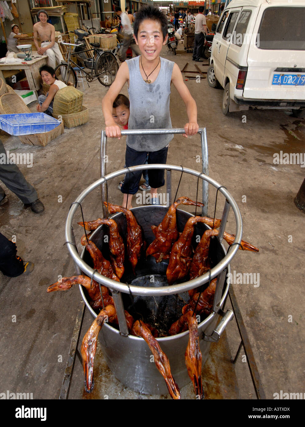 Chinese boy selling roasted ducks Kunming Yunnan China Stock Photo - Alamy