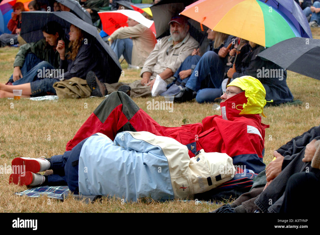 Sheltering from the typical British weather at Vibes From the Vines festival in Horam, East Sussex. Picture by Jim Holden. Stock Photo