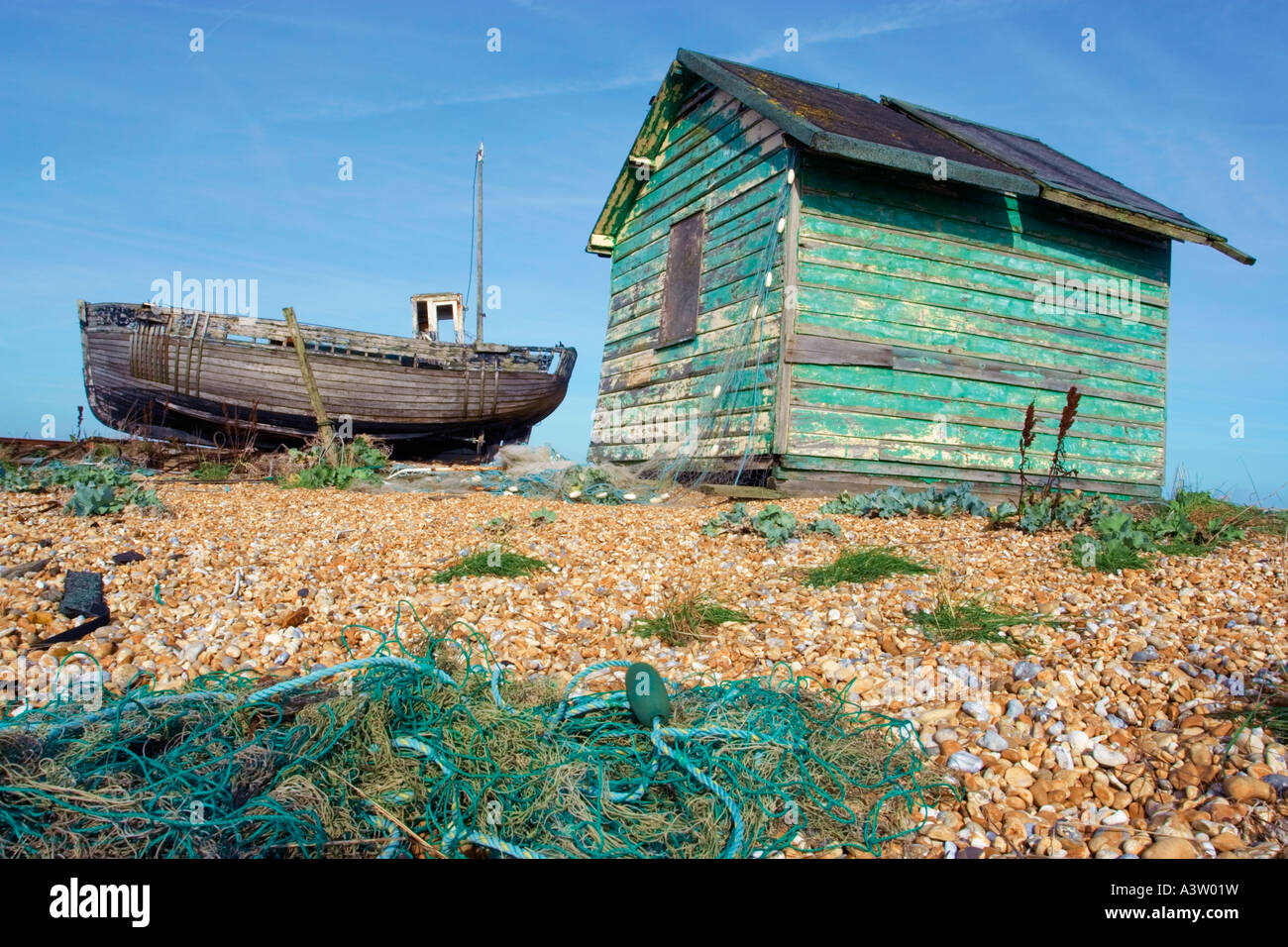 old fishing hut and beached boat Stock Photo Alamy