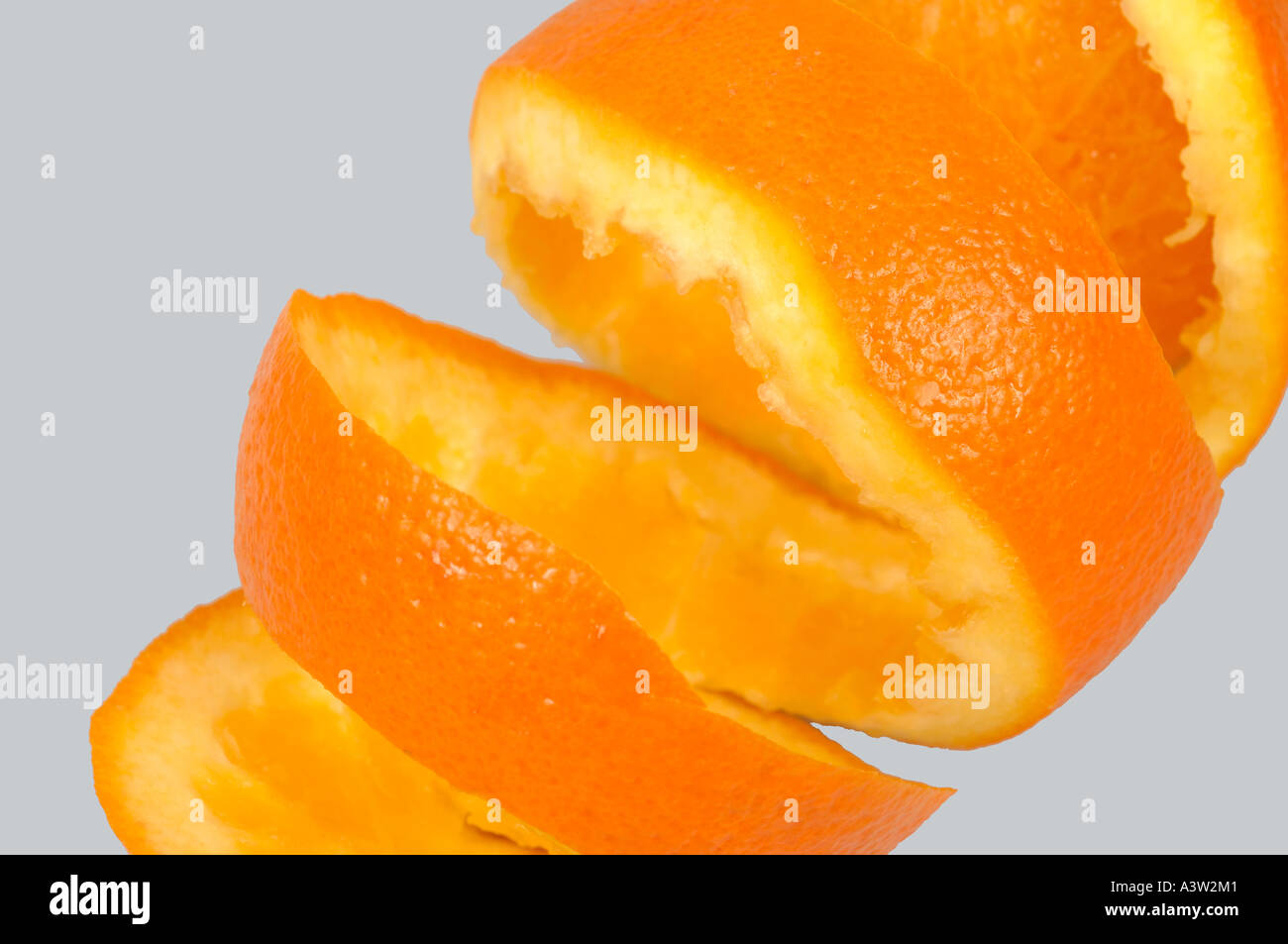 Harvested navel orange fruit with peel partially cut in a spiral Stock Photo