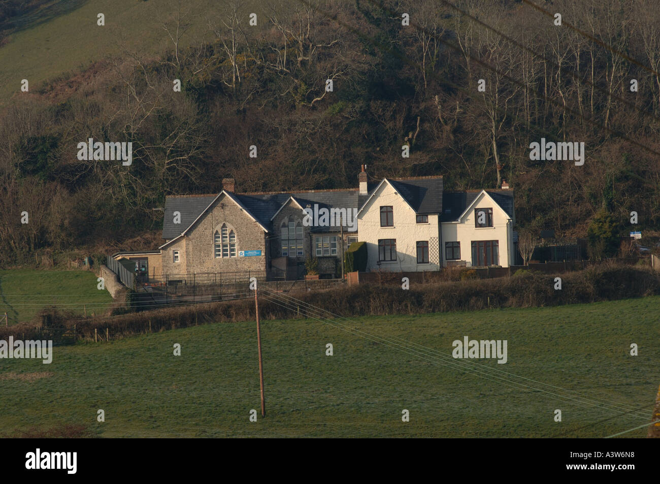 Coastal village of Branscombe Devon primary school lit by early morning winter sun Stock Photo