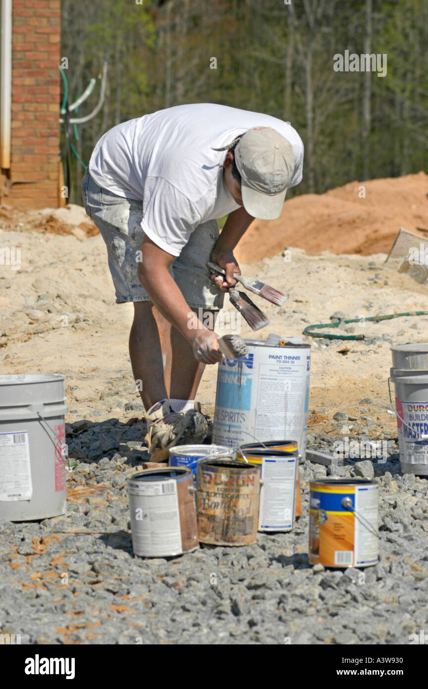 Hispanic Latin painter in construction site in Atlanta cleaning tools Stock Photo Alamy