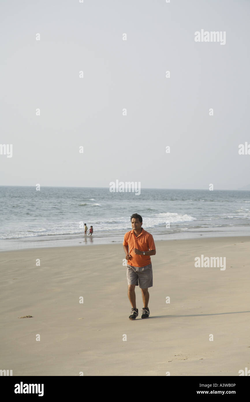 Asian man running on beach hi-res stock photography and images - Alamy