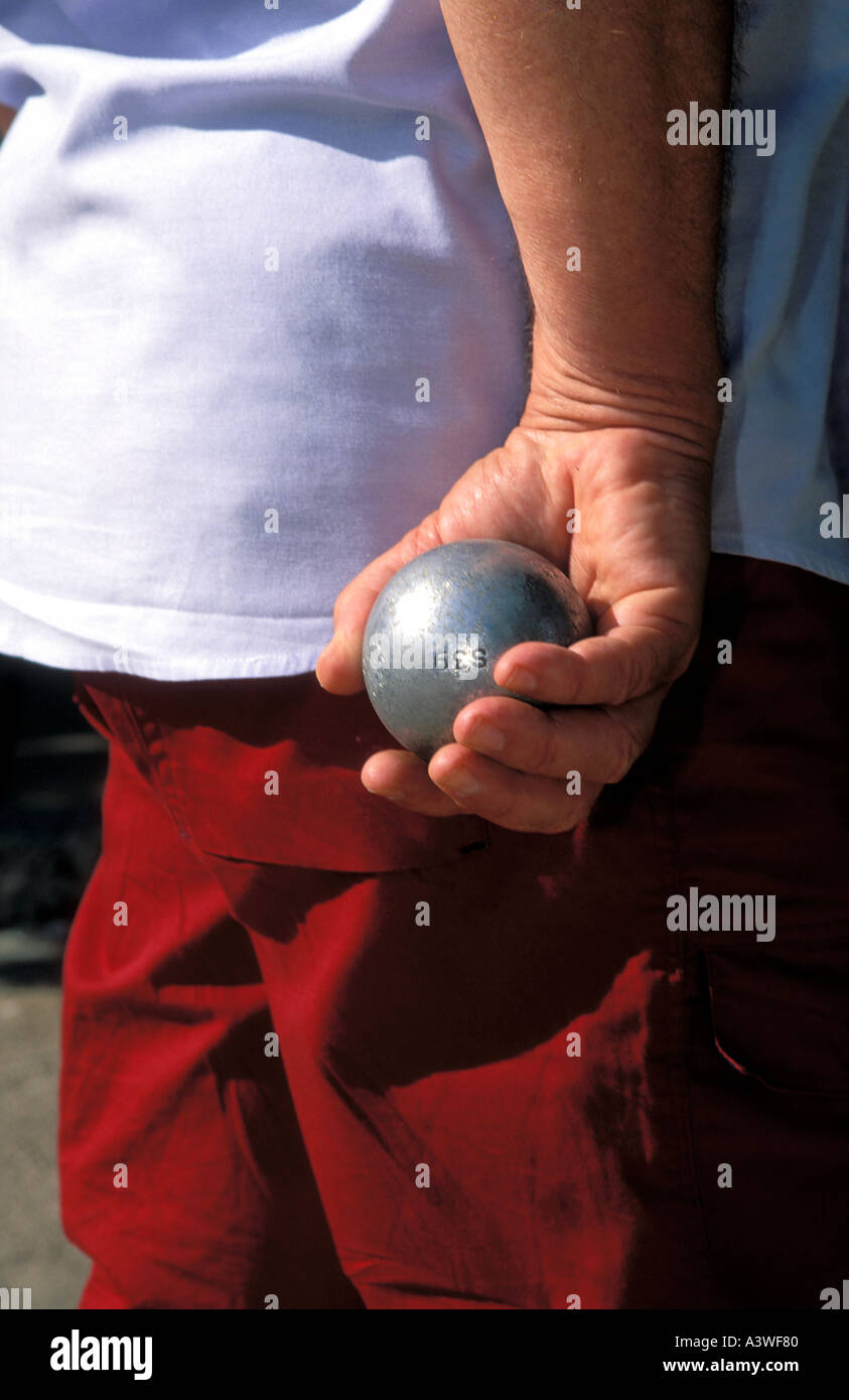Man playing bowls boules at a park in I lle Rousse Corsica Island France Stock Photo
