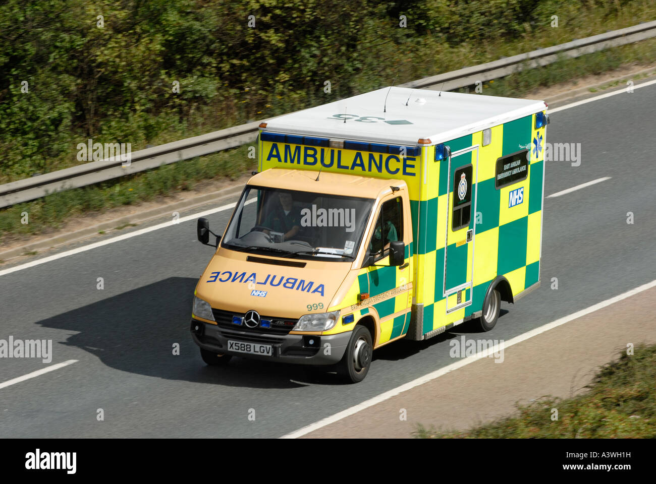 Ambulance driving along a road in the UK Stock Photo Alamy