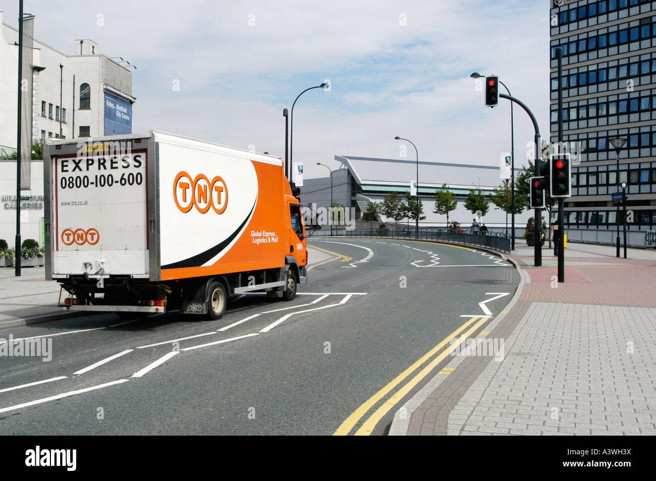 DAF delivery truck in use by TNT couriers waiting at a red traffic light in sheffield city centre Stock Photo