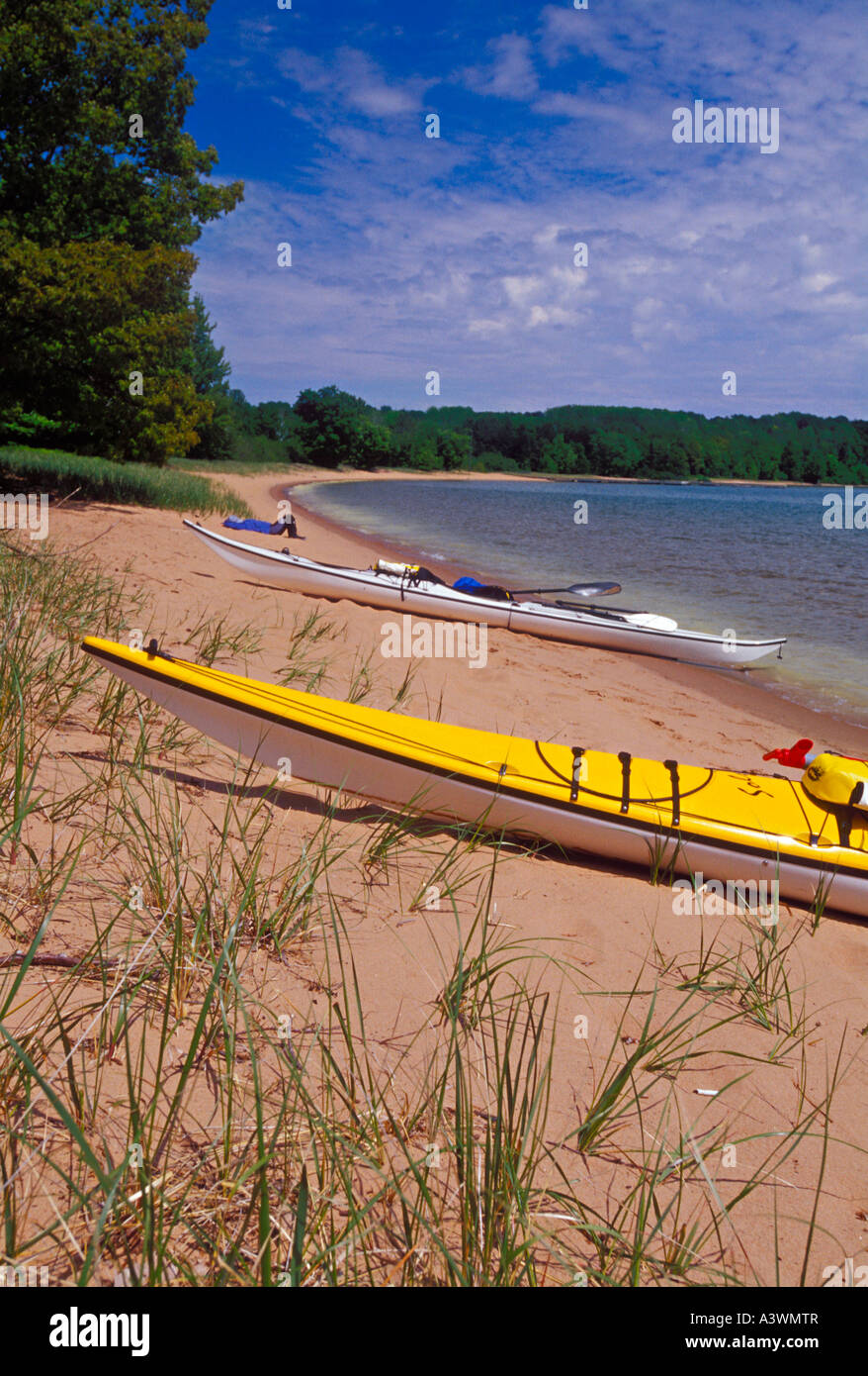 Sea kayaks beached on Stockton Island as a paddler rests in the Apostle