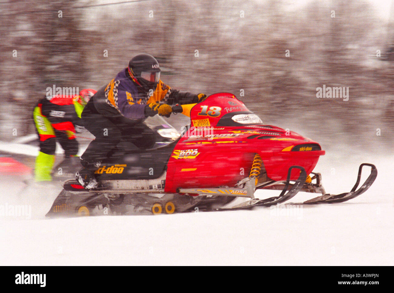 SNOWMOBILERS COMPETE IN A HILL CLIMB RACING EVENT AT MARQUETTE MOUNTAIN