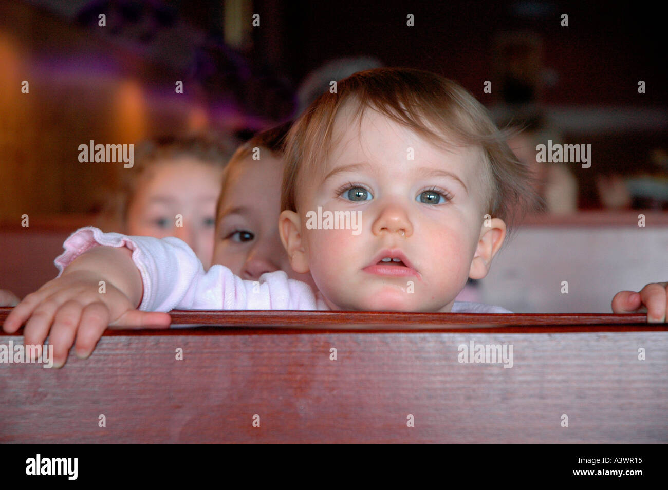 Kids in cafe showing off to brothers and sisters and family Stock Photo