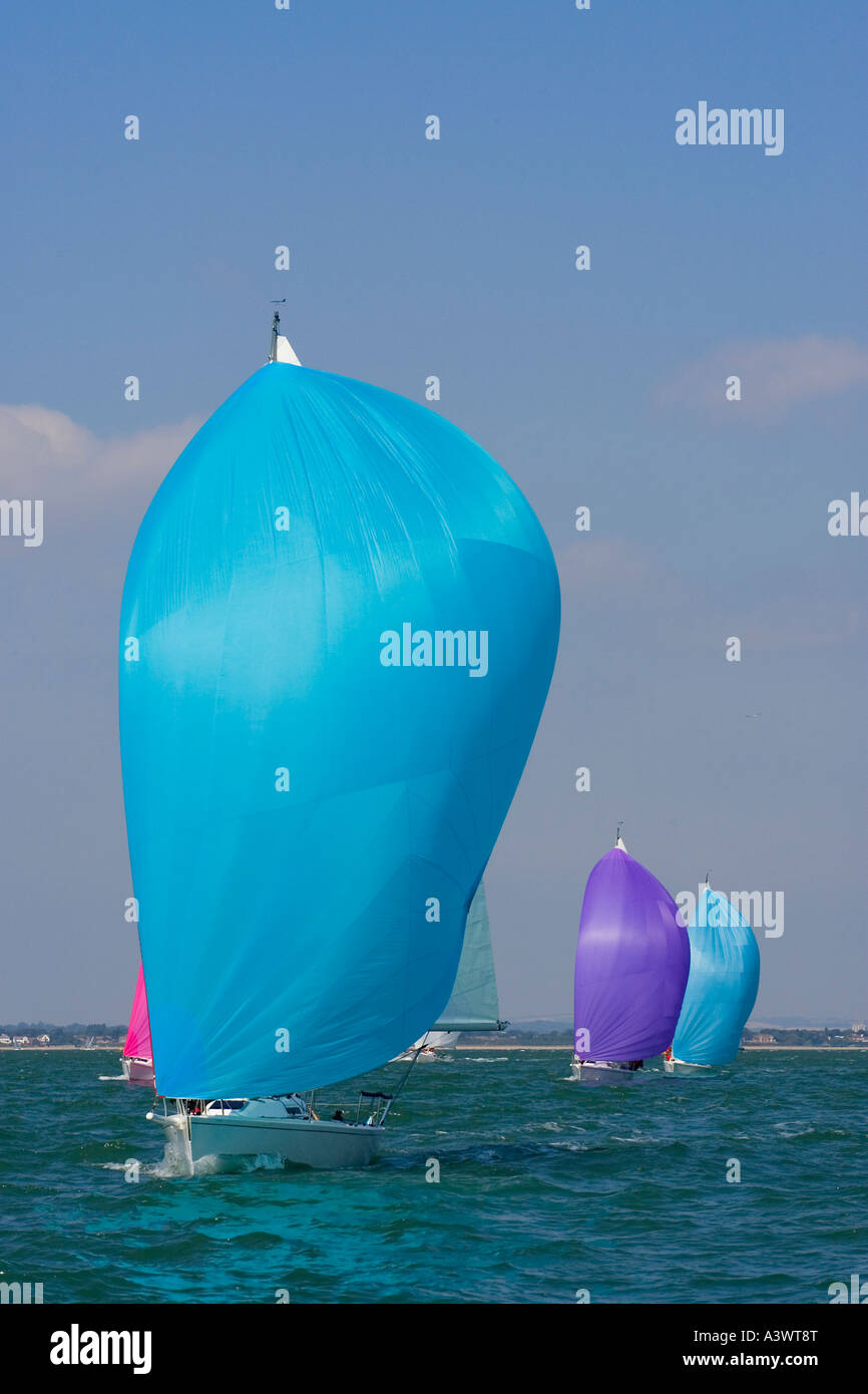 Yachts racing with coloured spinnakers raised Stock Photo