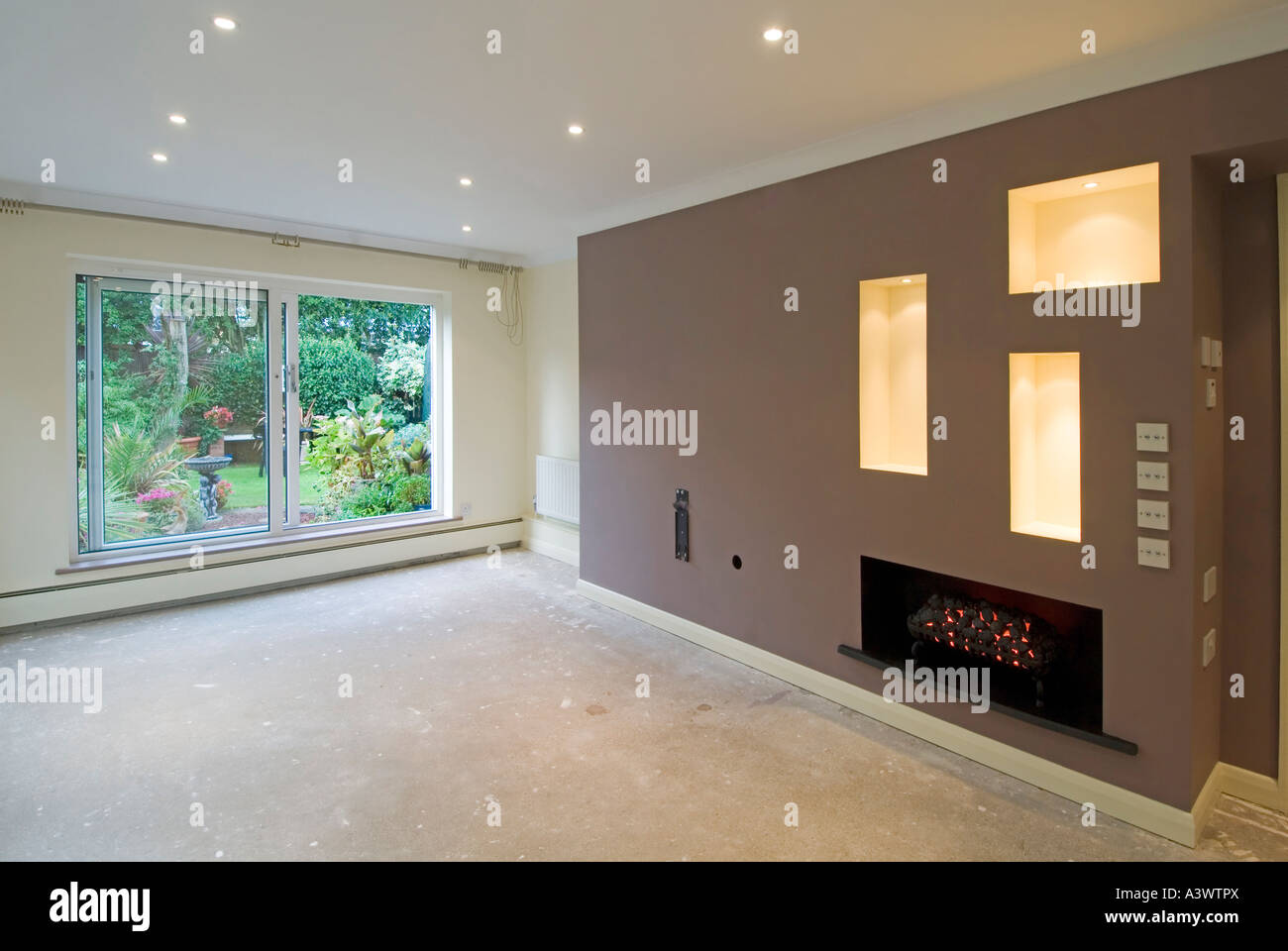 Home improvement makeover work to lounge living room interior new lighting testing wall alterations decorated awaiting carpet fitter Essex England UK Stock Photo