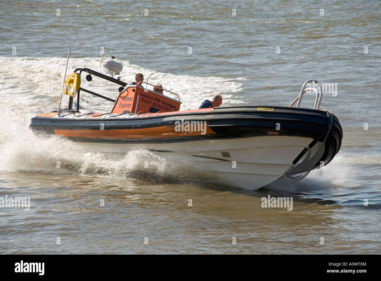 River Thames power boat based on inflatable construction carries out high speed manoeuvres near Canary Wharf Stock Photo