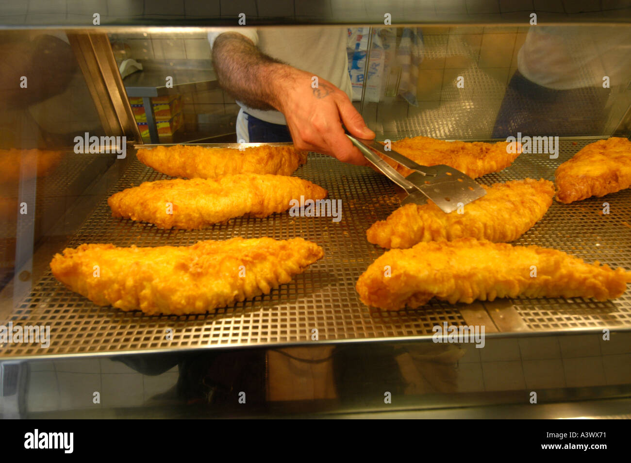 Cod fried in batter at fish and chips shop, England, UK Stock Photo