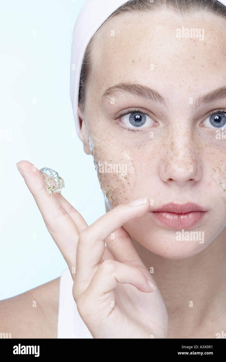 A young woman applying gel on her face Stock Photo Alamy
