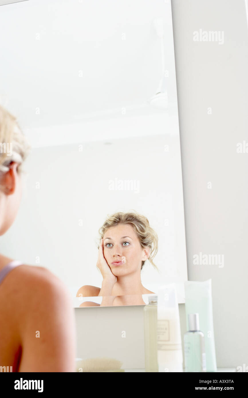 A young woman looking at herself in mirror low angle view Stock Photo