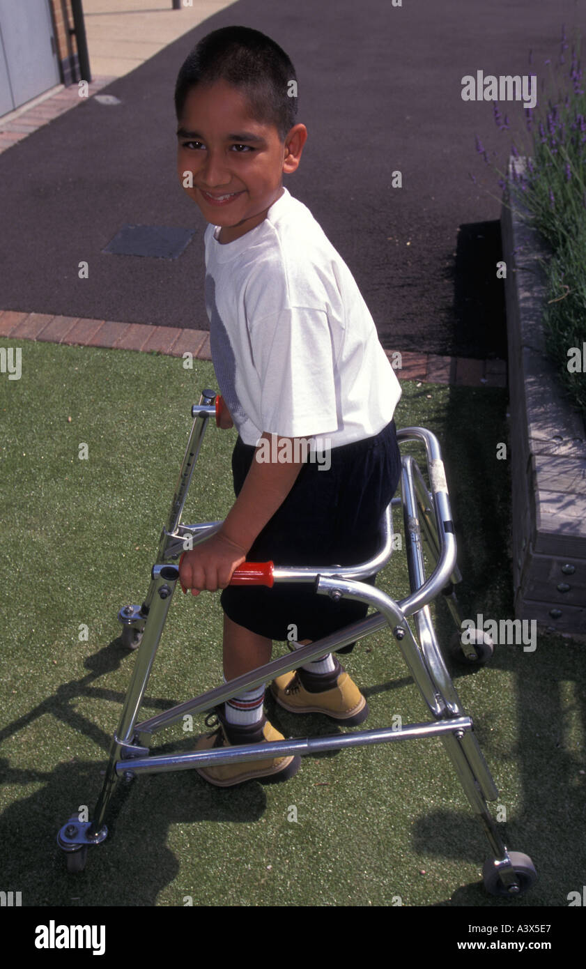 Young autistic boy at a special school using walking frame, London, UK ...