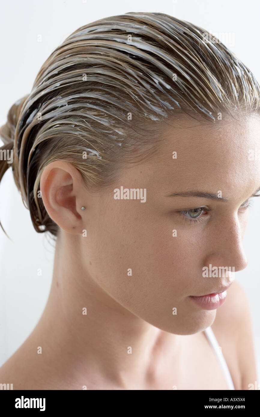 Young woman with cream in hair high angle view Stock Photo