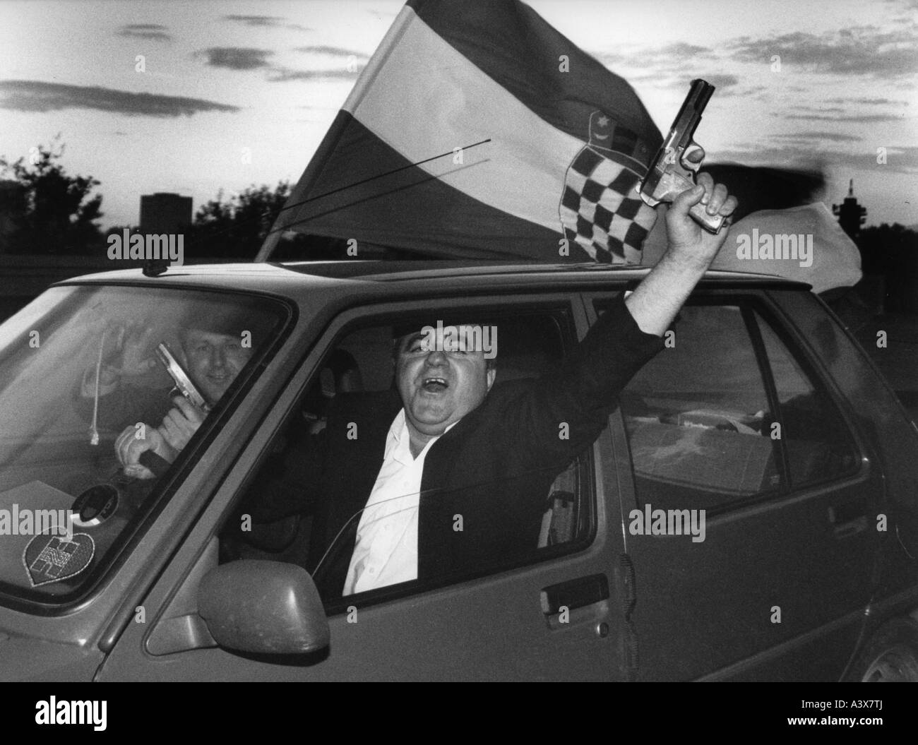 Cheering men with pistol and flag in a car hi-res stock photography and ...