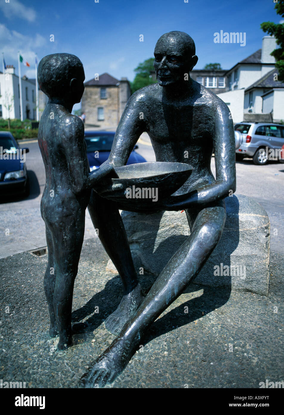 modern artistic sculpture of man and boy on an irish quayside Stock ...