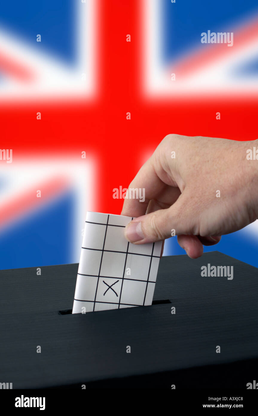 hand placing a vote into a ballot box Stock Photo