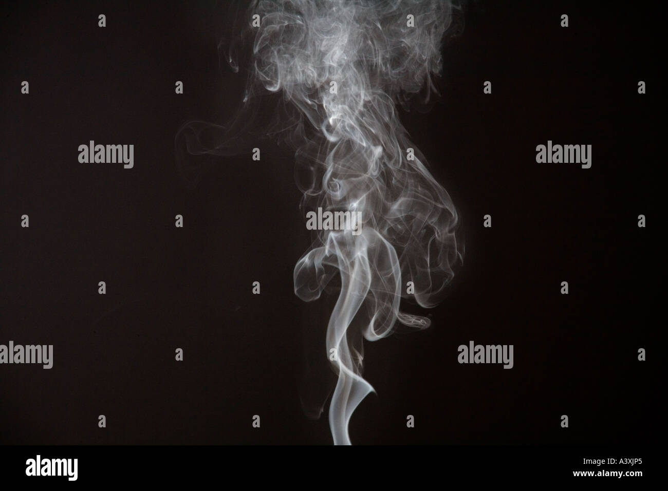 smoke against a black background Stock Photo - Alamy
