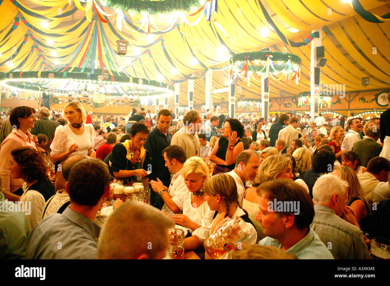 happy people in beer tent Oktoberfest in Munich Stock Photo